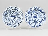 pair of blue and white plates with floral designs on them
