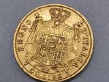 a close up of a gold coin with a crown on it