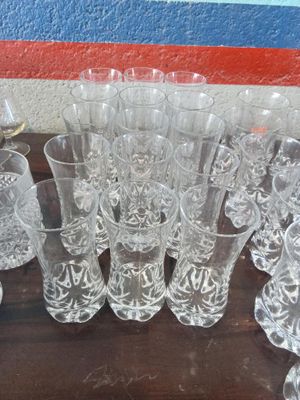 a lot of glasses sitting on a wooden table