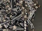 a pile of black and white lanyards on a table