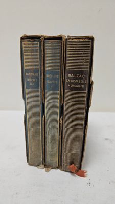 three books are stacked on top of each other on a table