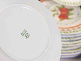 a white plate with a green and red design on it