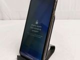 the iphone is sitting on a stand with a message on the screen