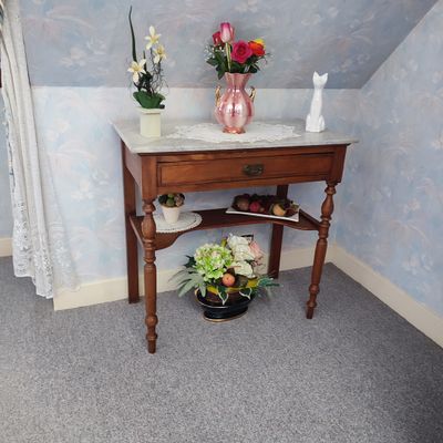a small table with a vase of flowers on top of it