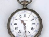 a small pocket watch with roman numerals on the face