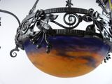 a blue and orange vase hanging from the ceiling