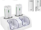 two batteries and a charger are sitting on a white surface