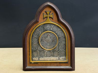 an image of a clock on a wooden table with a cross on it