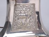 a silver plate with a lion head on it