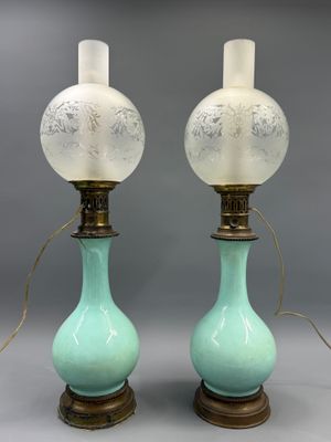 pair of green and white glass lamps on wooden bases