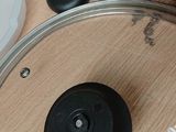 a pan with a lid on a table next to other items