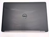 dell laptop computer with dell logo on screen on white surface