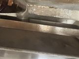 a metal object that is hanging from the ceiling of a kitchen
