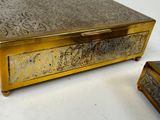 a gold box sitting next to a small box on a table