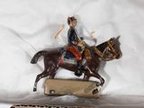 a figurine of a man riding a horse on top of a box