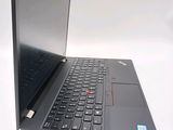 a laptop that is open on a white surface