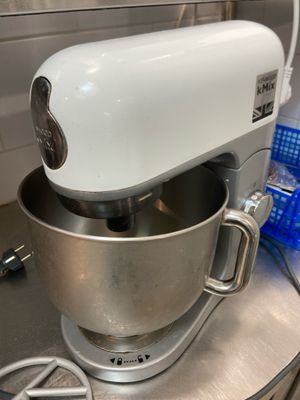 a white mixer sitting on top of a counter