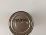 a close up of a tin of food on a white surface