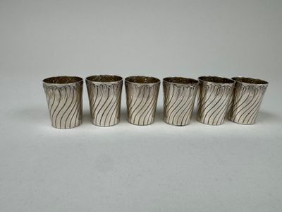 four silver cups with wavy designs on them