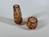 pair of brown glass salt and pepper shakers sitting on a white surface
