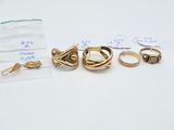 a bag of gold rings on a white table