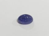 a close up of a blue sapphire stone on a white surface