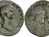 a silver coin with an image of a man and a woman on it