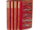four red books stacked on top of each other on a white surface