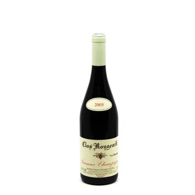 the bottle of wine is sitting on a white surface