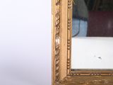 a picture of a gold framed mirror on a white wall