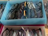 many pairs of glasses sitting in a box on the table