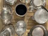 de nombreux plats et casseroles en argent posés sur un plateau en bois
