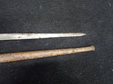 a pair of scissors and a hammer on a black surface