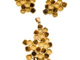 an image of a gold plated necklace and earring set on a white background