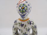 a figurine of a woman with flowers on it