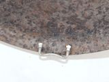 a metal plate with a metal handle on it