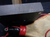 a knife that is being used to sharpe a piece of wood