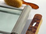 a mirror, brush, and comb sitting on a table