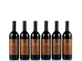 six bottles of red wine lined up on a white surface