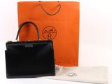 Sac à main Hermès en cuir noir avec finitions dorées et pochette assortie