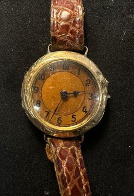 a watch that is sitting on a black surface