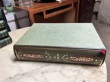 a green book sitting on top of a marble table