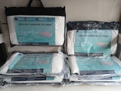 three bags of bedding sitting on top of a shelf next to each other