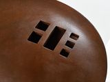 a brown object with a hole in it on a white surface