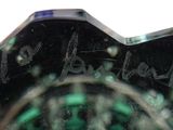 a close up of a black and green vase with writing on it