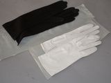 a pair of gloves sitting on a table next to a bag