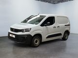 La camionnette blanche est garée à l'intérieur d'une grande pièce blanche.