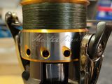 a close up of a fishing reel on a table