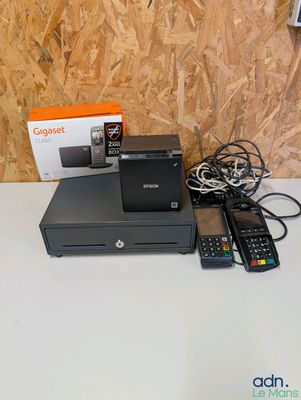 a box of remotes and a printer sitting on a table
