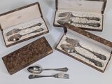 several silverware items are in a case on a white surface